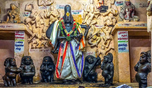 A unique Kankalanathar (Bikshaada Nathar) idol in Brahmadesam Kailasanathar Temple, surrounded by a lot of deities. Bikshaada Nathar is seven feet tall and is seen in a standing posture.