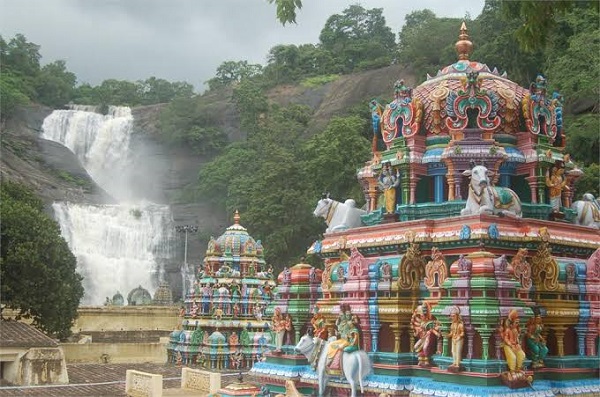 View of the Piravipini Theerkum Thirukutralam Temple gopuram with the Courtallam main falls in the background. 