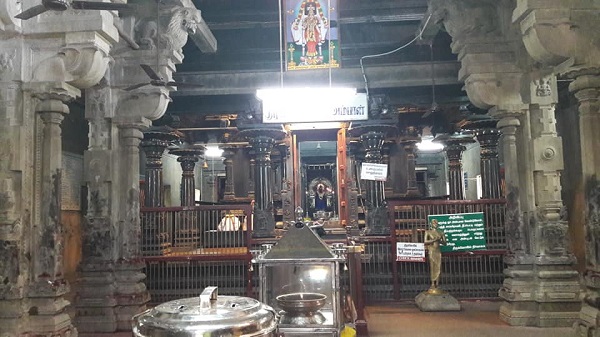 Inner view of the Thirukuttralam temple with its majestic stone pillars, and the Lord's shrine.