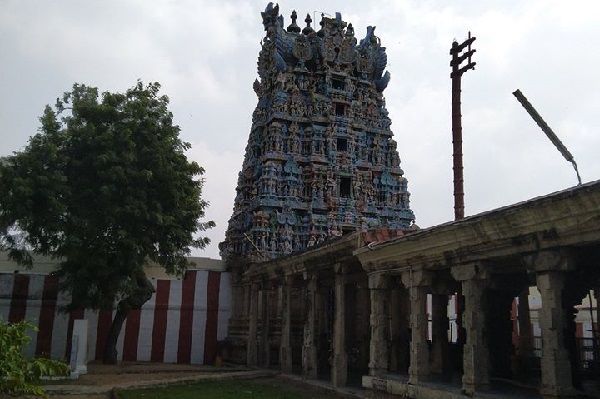 Thiruvaragunamangai Perumal Temple's inner view with the mandapam with stone pillars in the foreview and Gopuram and flagpole in the background. 