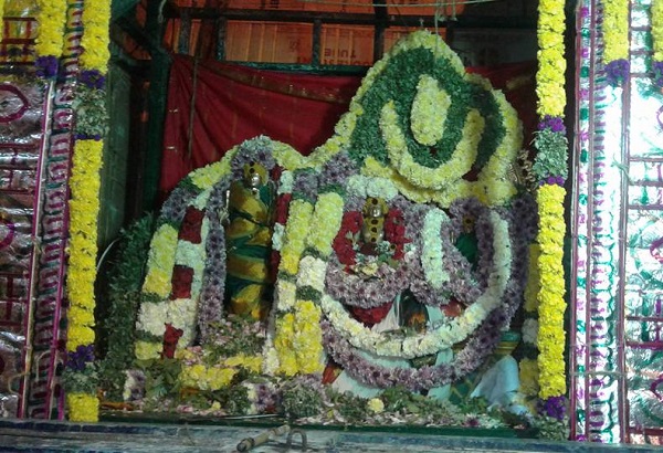 The presiding deity of Palayamkottai Sivan kovil and his divine consort are bedecked in silver attire and multi-coloured flower garlands.
