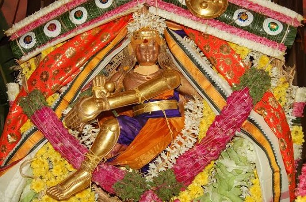 The statue of Thirukuttralanathar decorated with silk clothes and flower garlands in Piravipini Theerkum Thirukutralam Temple