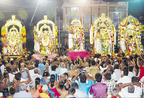 Srivaikundam temple idols procession with priests performing aarthi and a crowd of devotees offering prayers