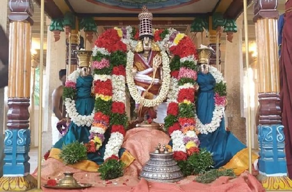 In the corridor of Thirutholaivillimangalam Srinivasan temple, Urchavar Devarpiran and his two wives Sri Devi and Boo Devi are decorated with colourful flower garlands for dharshan.