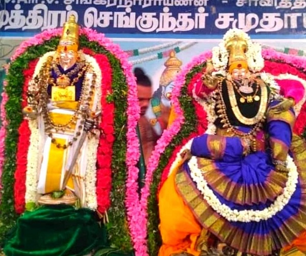 Idols of agathiyar and lobamudhrai ammai decked with ornaments and flowers.