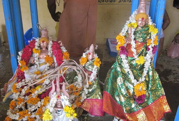Golden idols of urshavar with his two wives decorated with garland in Ambasamudram Kasipanathar Kovil Temple