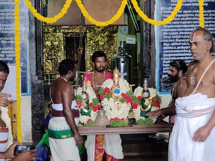 Priests performing sacred rituals during karungulam temple festival.