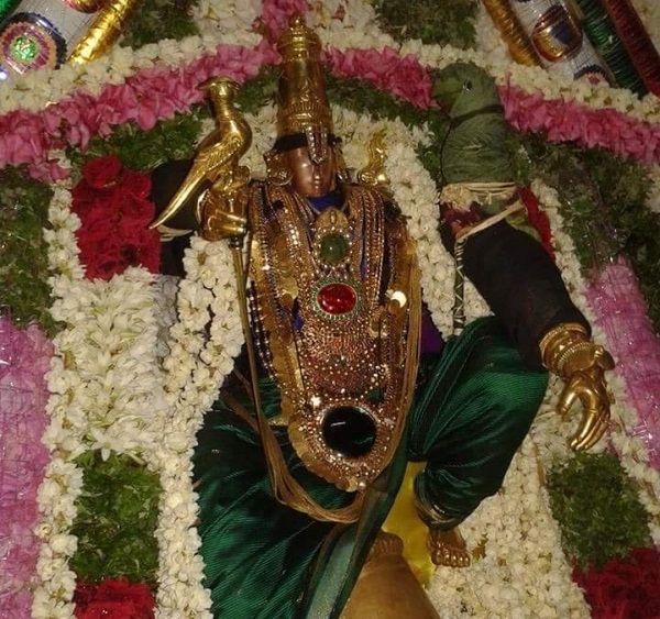 Karungulam temple swamy decorated with jewellery and flowers.