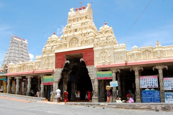 The side entrance to the Thiruchendur Subramanya Swamy temple with the main gopuram in the background.