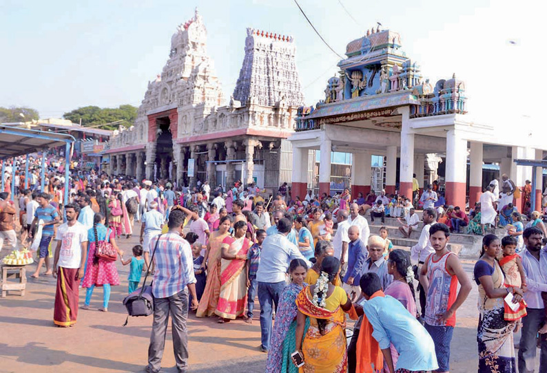 View of the gopuram and the temple complex with hundreds of devotees thronging the open area outside the temple to attend the Kandha Shasti Vizha.