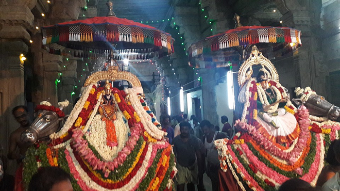 The presiding deity of Nellaiappar temple with his consort taken out in a festive procession on a platform decked with flowers and garlands. 