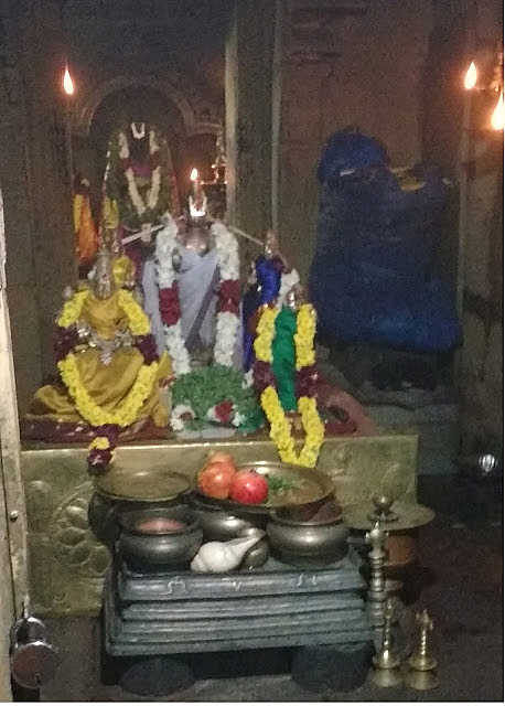 An inner view of Sivalaperi Sundarraja Perumal main shrine with idols decorated beautifully and Pooja items placed in front of the deities in Tirunelveli