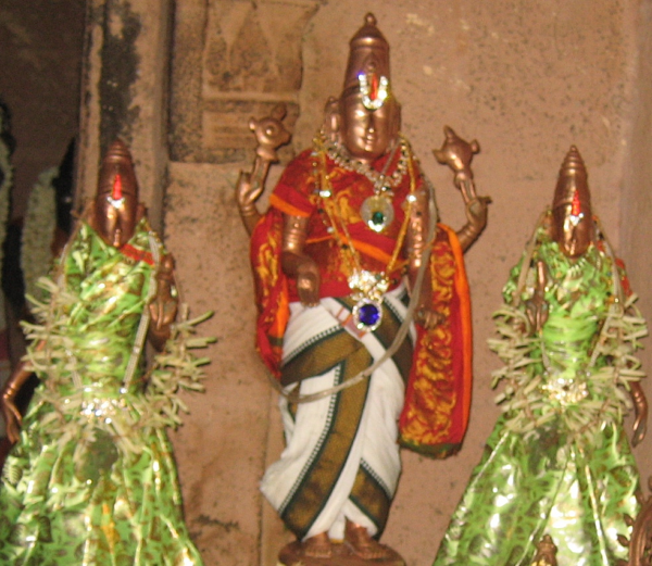 A close-up view of Sivalaperi Sundararaja Perumal brass idol along with idols of goddesses adorned in silk clothes in Tirunelveli