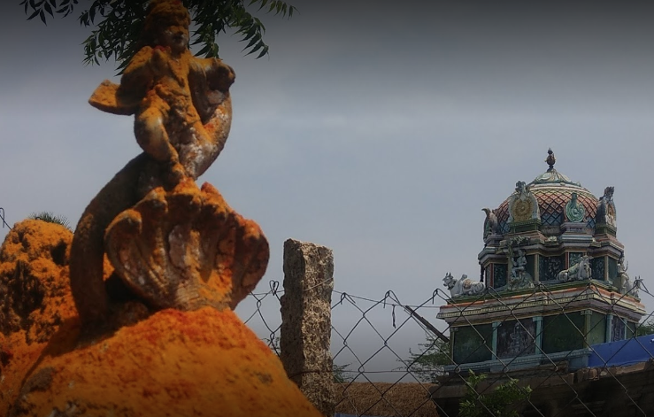  An idol of little Krishna dancing on the Kalinga snake in the back drop of Kodaganallur Kailasanathar temple gopuram