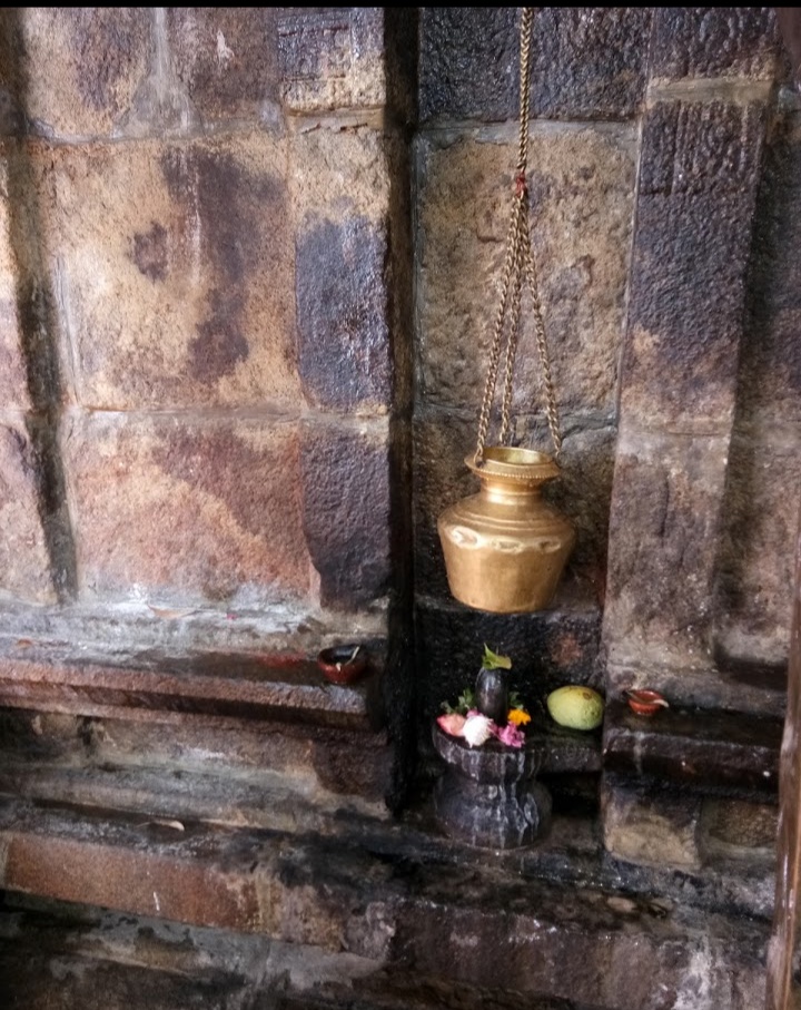 Abhishekam is performed on a Siva lingam, placed on a wall of the temple interior, from a brass pot hung by a brass chain in Melaveeraragavapuram Chokkalingaswamy Temple in Tirunelveli. 