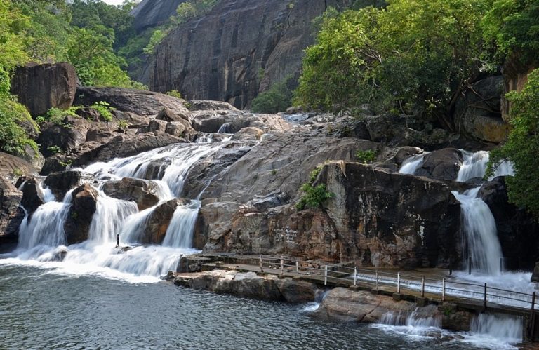 View of the majestic Manimuthar falls and the mountains of the Western Ghats in the background near Manjolai
