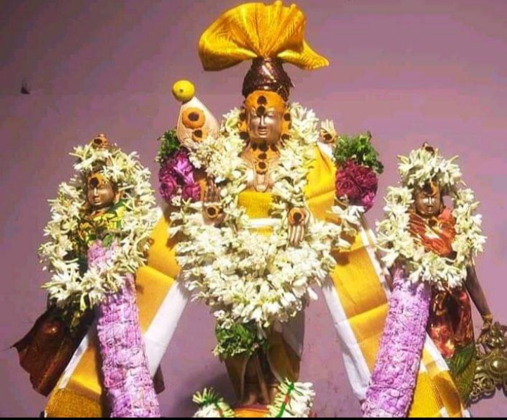 Idols of Palayansalai Kumaraswami, Valli and Devasena beautifully adorned with silk clothes and flower garlands.