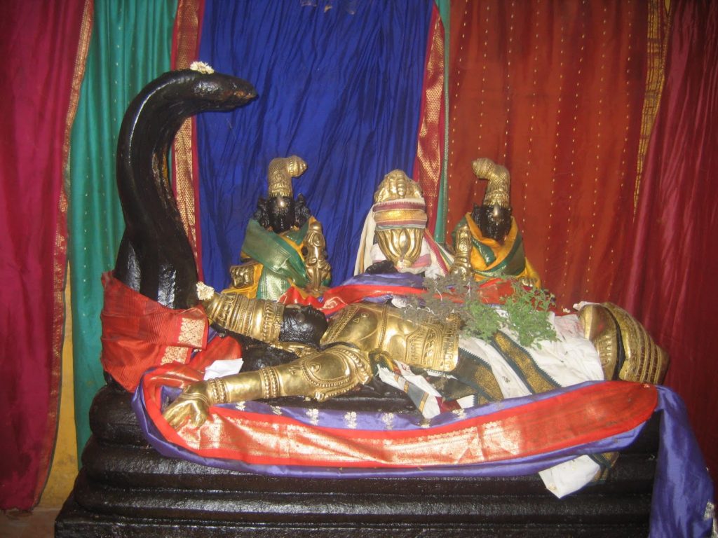Black idol of Ranganathar in a colourful background in Sri Kariya Manikka Perumal Temple in Tirunelveli 