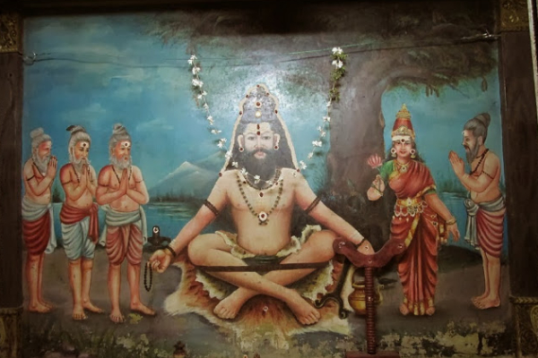 Framed photo of kasiba munivar with some devotees worshipping him.