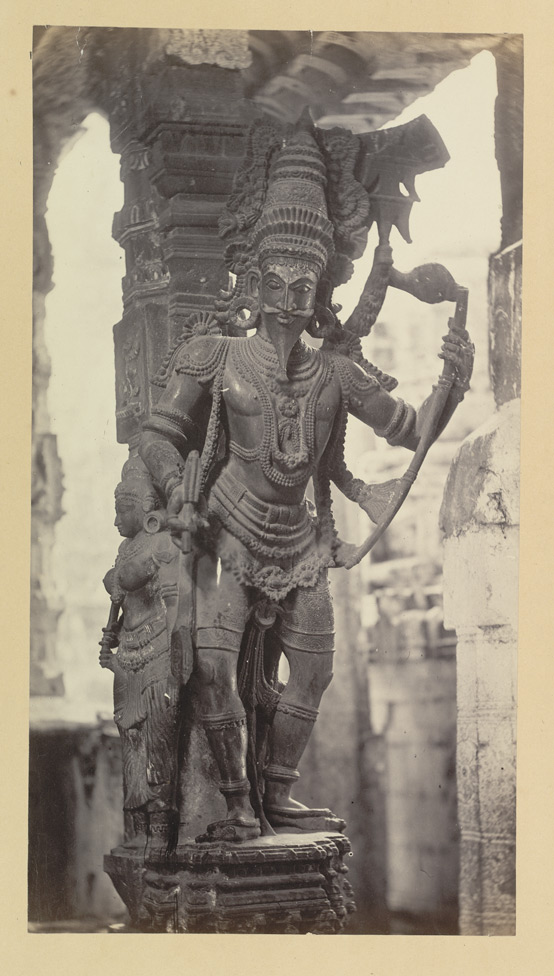 Stone statue of a hindu god with a bow and arrow on one hand and a sword on the other hand.
