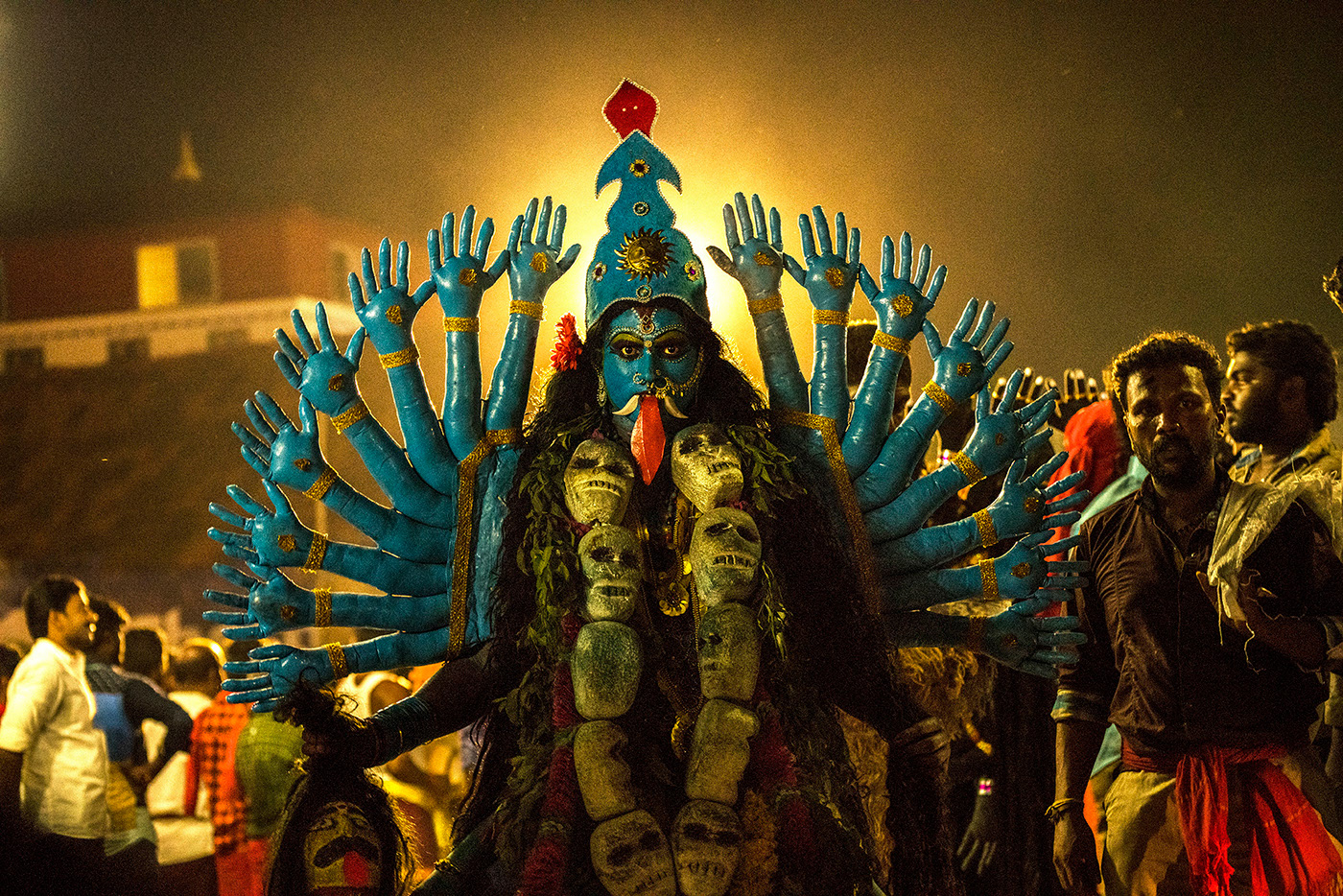 Goddess Mutharamman devotee has put make up as Goddess Kaali, with 16 hands and garland made of skull.