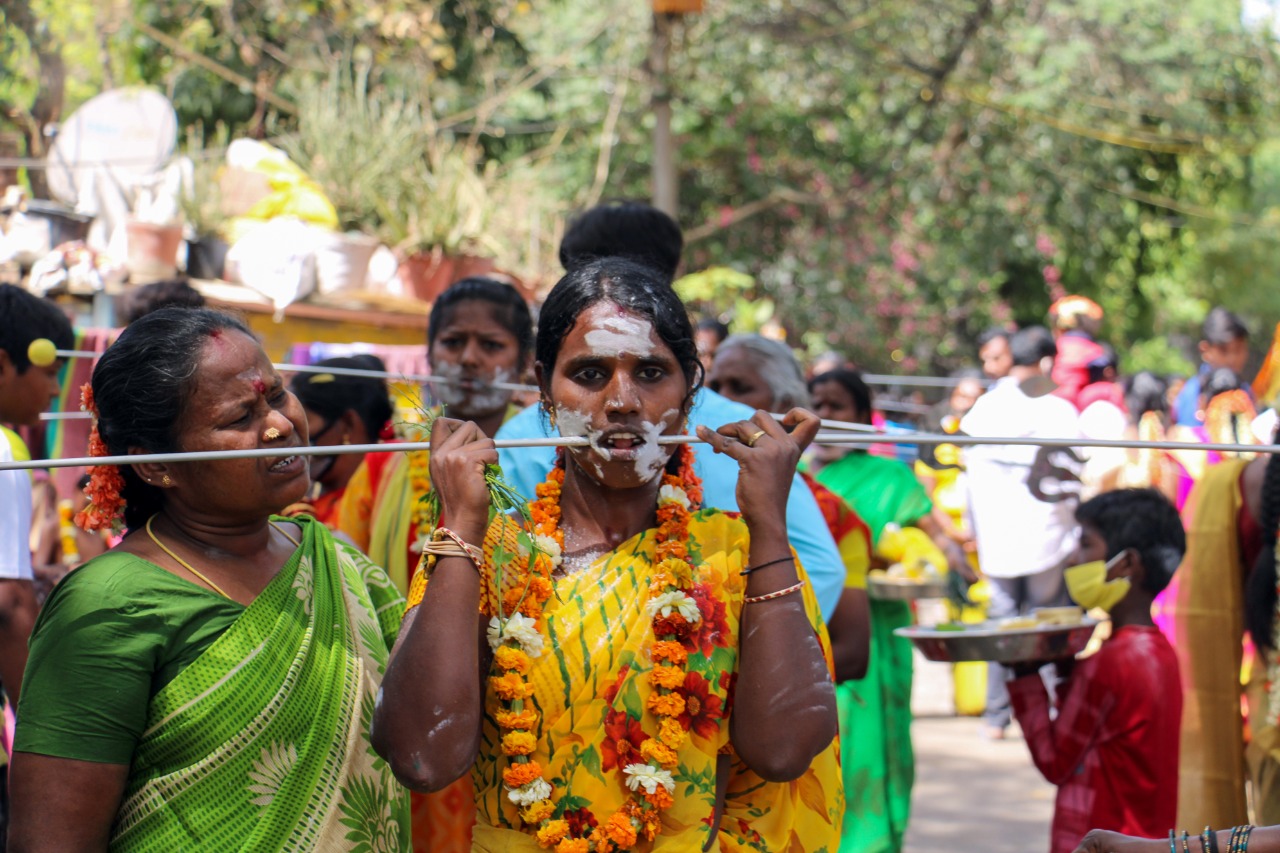 A woman devotee performing a religious ritual during Panguni Uthiram. 