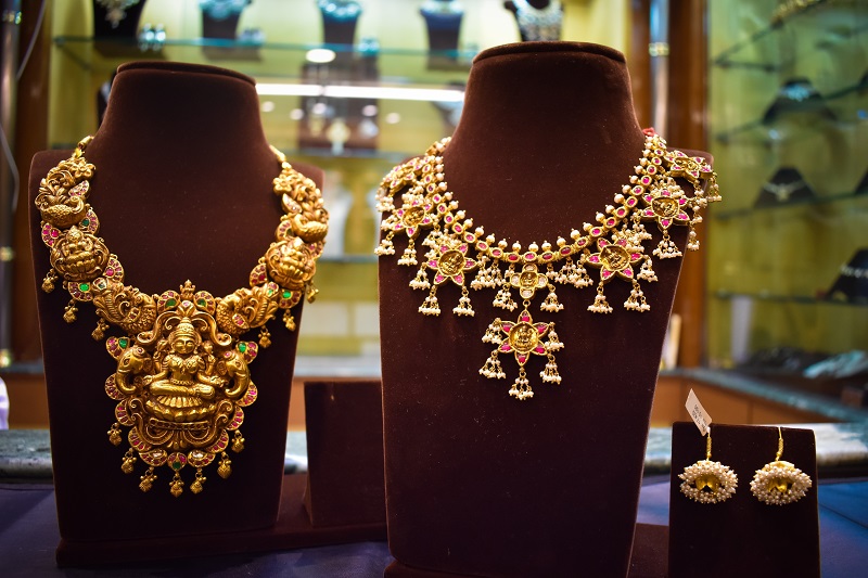 Antique golden temple jewelry is showcased in a jewelry store on Akshaya Tritiya.